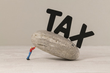 man collapses under the tax burden
