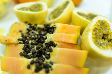 Tropical fruit cut and in dishes.