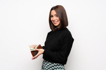 Young woman over white wall holding a wallet