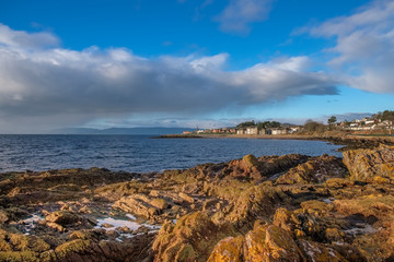 Scottish Town of largs Looking Over Lichen Covered Rocks into the Town