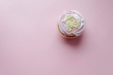 pink cream cupcakes and macaroon on pink background