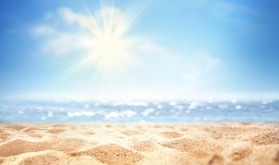 Summer background, nature of tropical golden beach with rays of sun light. Golden sand beach, sea water against blue sky with white clouds. Copy space, summer vacation concept.
