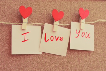 Red hearts hung with clothespins. Happy lovers day card mockup. Valentine's Day concept with heart. Top view. Copy space.background for love content or valentine day or about married.Festive concept.