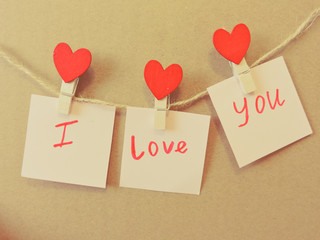 Red hearts hung with clothespins. Happy lovers day card mockup. Valentine's Day concept with heart. Top view. Copy space.background for love content or valentine day or about married.Festive concept.