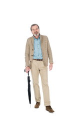 Obraz premium cheerful man holding umbrella in hand and standing isolated on white
