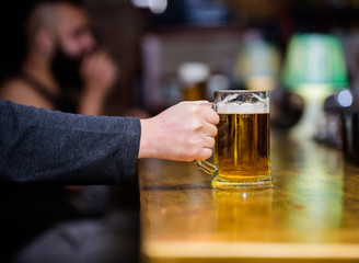 Friday leisure tradition. Beer pub concept. Weekend lifestyle. Beer mug on bar counter defocused background. Glass with fresh lager draft beer with foam. Mug filled with cold tasty beer in bar