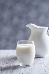 Pouring fresh milk into glass close up.