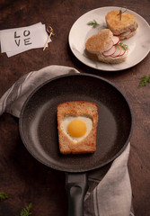 fried eggs with bread in a skillet and radish sandwiches 