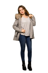 A full-length shot of a Teenager girl with coat with a lot of heat on isolated white background