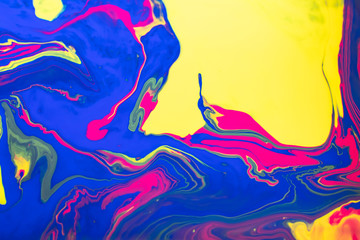 Abstract painting background in vivid colors. Marbleized bright effect with fluid painting, background for wallpapers, poster, postcard. Swirls and lines with yellow, blue, magenta white. Pop colors