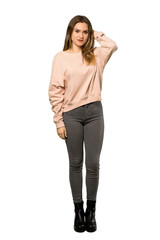 A full-length shot of a Teenager girl with pink sweater having doubts over isolated white background