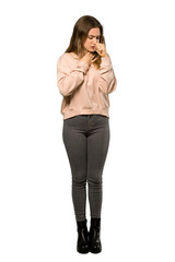 Fototapeta premium A full-length shot of a Teenager girl with pink sweater is suffering with cough and feeling bad over isolated white background