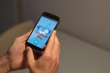 Hands holding mobile phone with a website on the screen that offers ideas to celebrate and surprise the beloved in the valentine's day