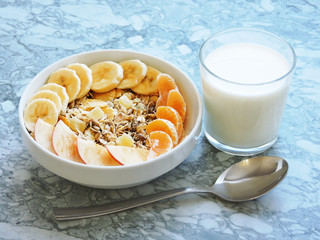 Healthy breakfast. Close-up, top view, isolated background. Concept of healthy and tasty food. Fitness breakfast. muesli bowl with sliced banana. Muesli breakfast with oatmeal cereals raisins. 