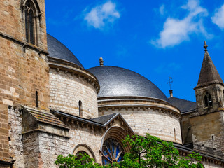 Fototapeta na wymiar Cahors Cathedral round domes, with sunlight, and blue sky background, Lot, France