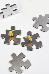 Obraz premium metal puzzle on a white background