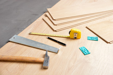 Planks of laminate floor and tools to install them