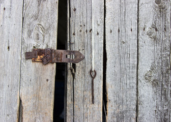 Dark wooden gate with metal lock, background image