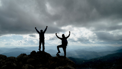 happy climbers reaching the goal and peak success