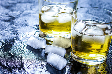 glass of whiskey on dark background