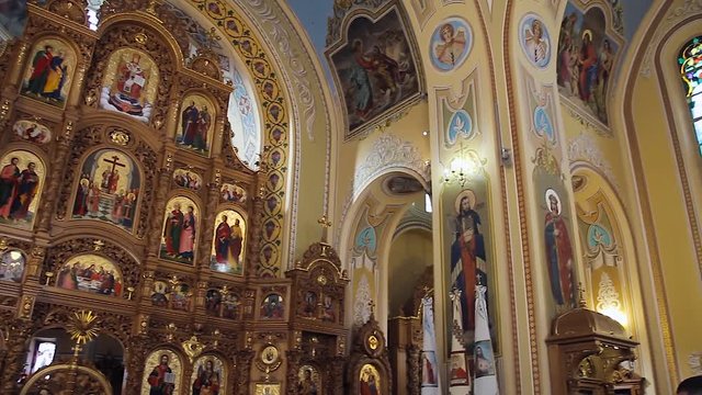 Great hand-painted domes of the cathedral, iconostasis, sun rays in the church