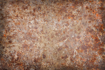 Corroded and rusty background surface with vignetted lighting