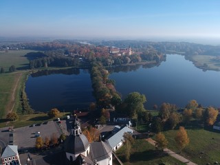 Drone photo of Nesvizh Castle in autumn on a hazy day. Minsk Region, Belarus. Site of residential castle of the Radziwill family. 