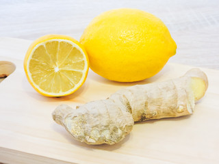 Lemons and ginger on a white background.Healthy food. Ginger Root Tea with Lemon. Healthy ingredients against cold.Top view image of lemon and ginger with copy space. get rid of toxins and boost.