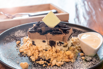 Close up of biscuit crumble cheese cake served with vanilla sauce