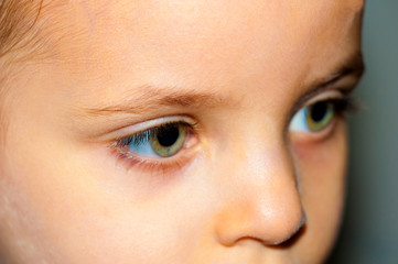 Close up view of a green girl's eye looking at camera