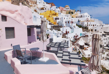 Sunny morning view of Santorini island. Famous Greek resort Oia, Greece, Europe. Traveling concept background. 