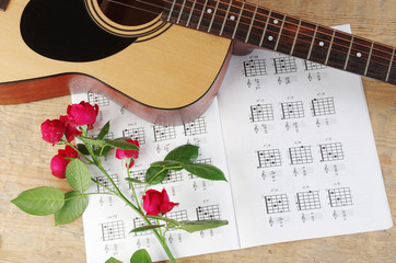 Acoustic guitar and table of chord. Learning to play the guitar