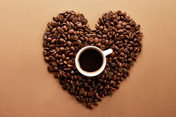 Roasted brown coffee beans scattered on white table with a lot copy space for text. Flat lay composition. Close up, top view, background.