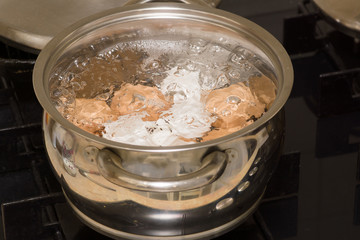 in a saucepan in boiling water large pieces of meat