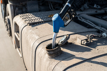 Truck at gas station refueling tank. Transport and fuel.
