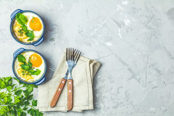 Baked eggs  in blue ceramic baking molds