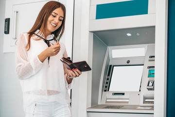 Woman withdrawing money from ATM machine