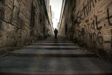 Fototapeta na wymiar A man walking right up the long stairs