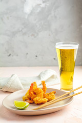 Shrimps tempura in plate and glass of beer