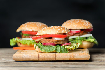 Fresh home made burgers on wooden table