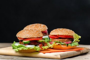 Fresh home made burgers on wooden table