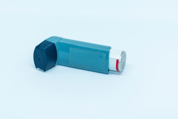 Blue asthma inhaler with white background