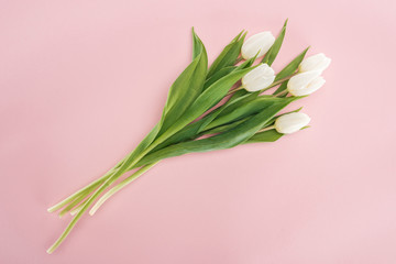 top view of spring bouquet with white tulips isolated on pink