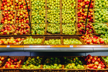 Fresh red and green apple fruits in a supermarket. Different kind of apples on cell