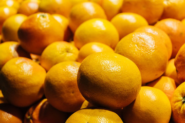 Fresh ripe grapefruits close-up in a supermarket. Citrus background