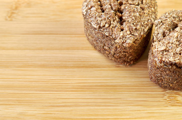 Closeup of rye wheat bread on a cutting board made from noble bamboo. homebaked bread. healthy food. copy space