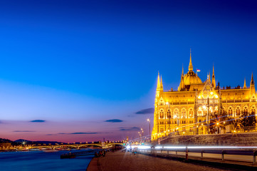 Obraz premium Parliament and riverside with light trails in Budapest Hungary during blue hour sunset