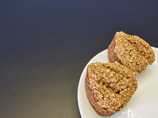 high-quality bread from sprouted wheat heart shape on a white plate of Chinese porcelain on a black background in the corner of the frame. homebaked bread. healthy food. breakfast. copy space