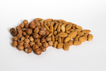 handful of nuts on a white background, almonds and hazelnuts
