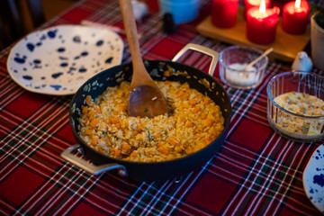 pumpkin risotto served with pan on dining table